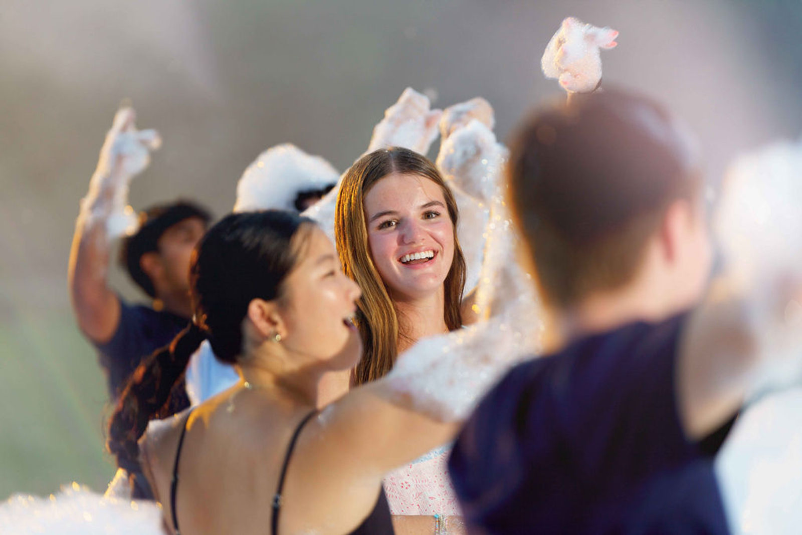 Guests laughing in the foam at a Windy City Foam party