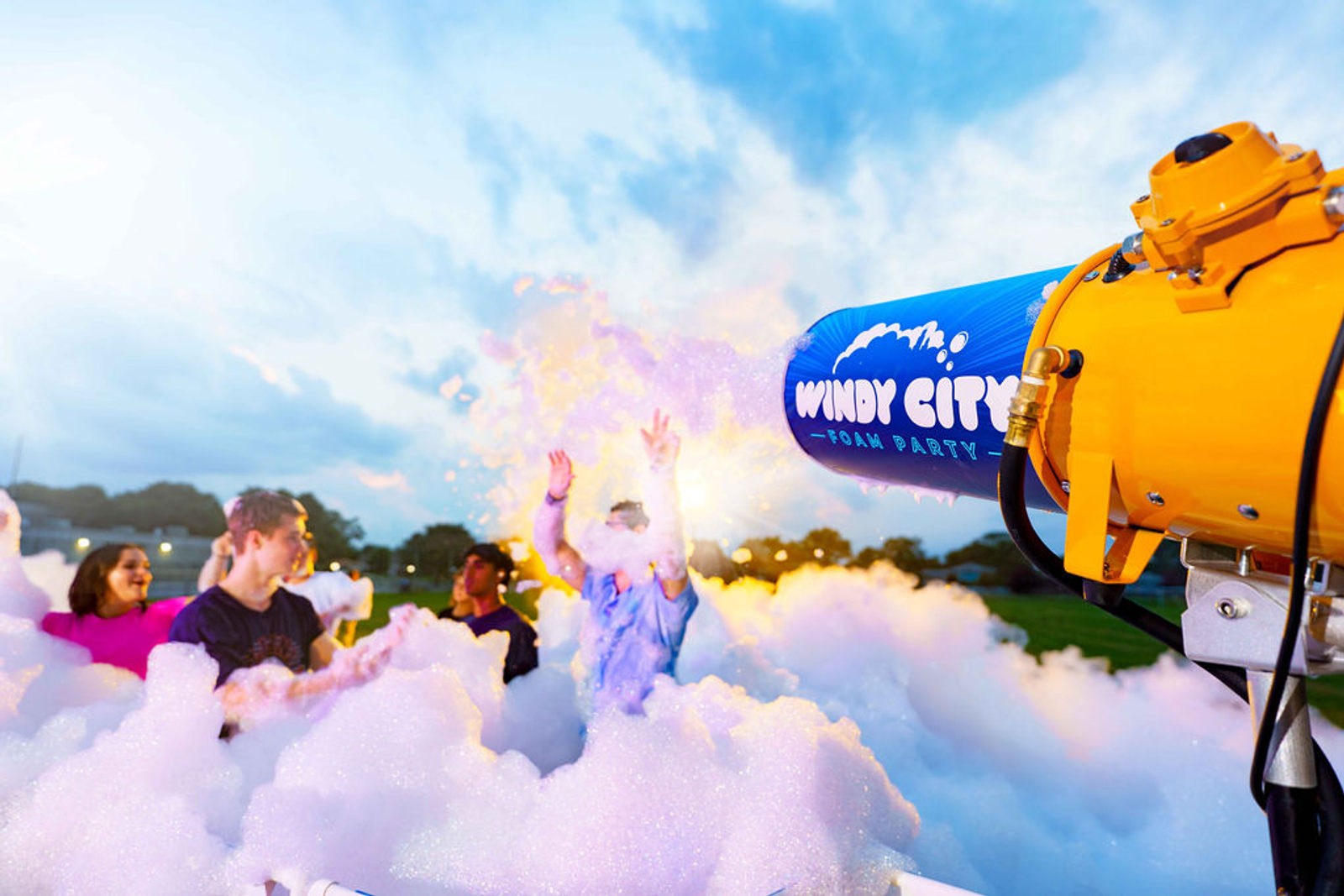 Guests dancing in foam beside a Windy City Foam cannon